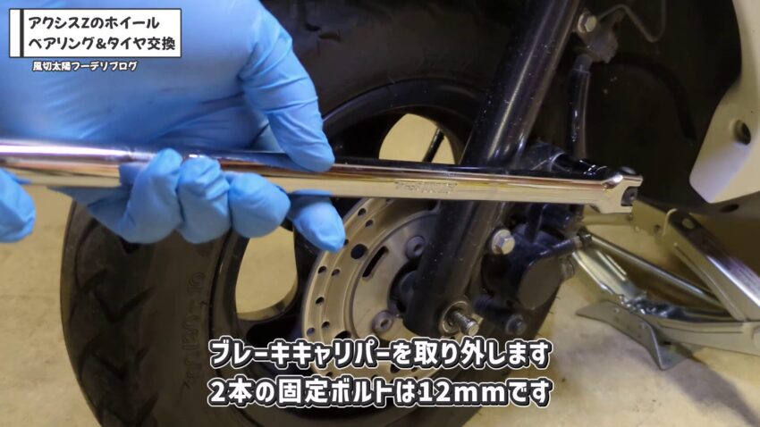 アクシスZのブレーキキャリパーを固定している2本の12mmのボルトを緩めています